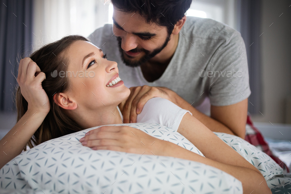 Beautiful Couple Is Smiling And Hugging While Spending Time Together In Bedroom