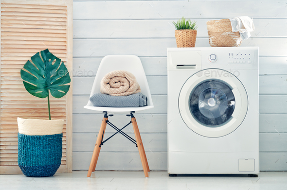 laundry room with a washing machine - Stock Photo - Images