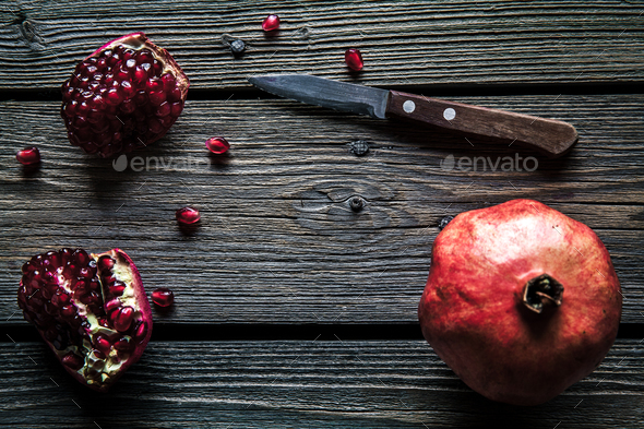 Fresh pomegranates on a wooden background. Organics, fruit, food - Stock Photo - Images