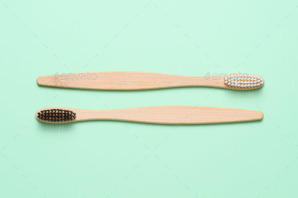Download Bamboo Toothbrushes On Light Green Background Top View Stock Photo By Anatoliysadovskiy