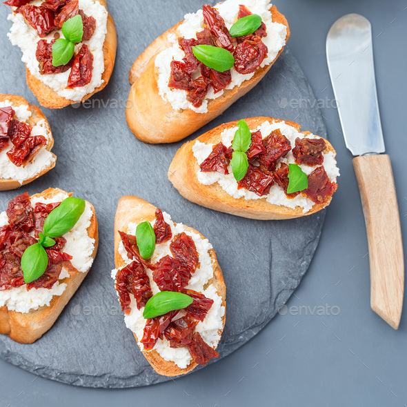 Bruschetta with sun dried tomato, feta and philadelphia cheese a Stock