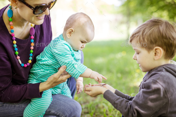 Caucasian young woman holding baby daughter - Stock Photo - Images