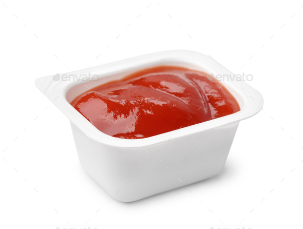 Open ketchup fast food dip packet - Stock Photo - Images