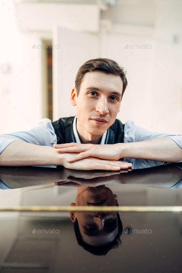 Pianist at the piano, perfectly polished surface - Stock Photo - Images
