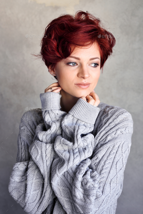 Portrait of a beautiful young red-haired woman with short hair w - Stock Photo - Images
