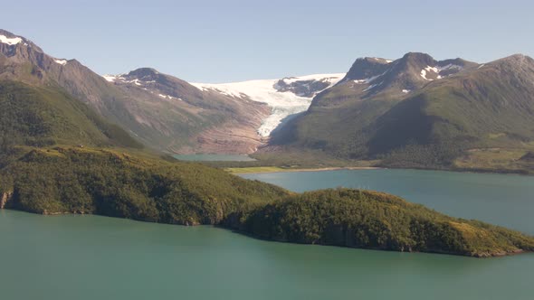 Aerial shot of Svartisen Blackice Glacier beside idyllic Fjord during sunlight - Helgeland, Northern alt