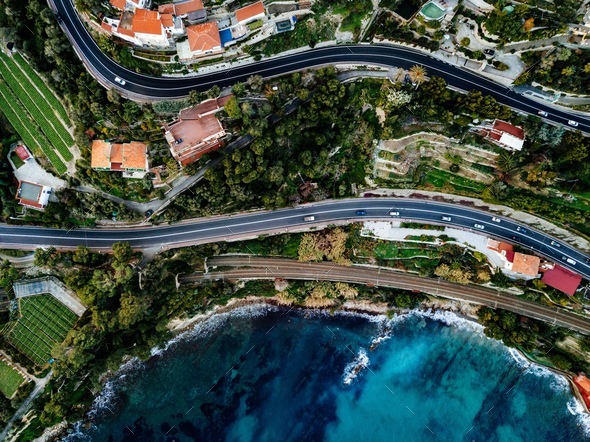 Aerial view of road, highway and railway going along ocean or sea. Drone photography in rural Italy - Stock Photo - Images