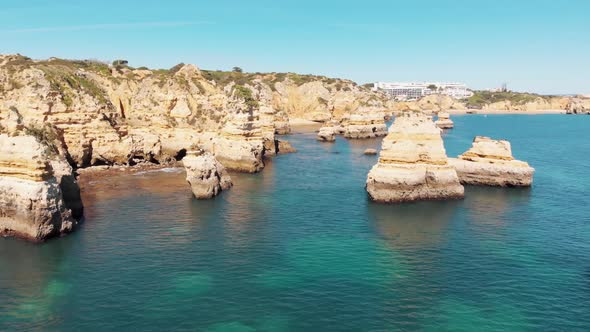 Fly through Rocky Idyllic Lagos Ocean Coast in Algarve, Portugal - Aerial shot alt