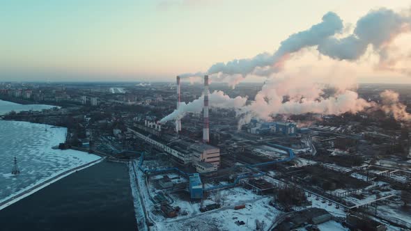 Smoking factory chimneys. View of large plant with Smoking pipes alt