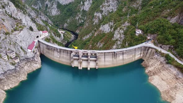 Bird's Eye View of Dam with Sky Blue Water in Mountains