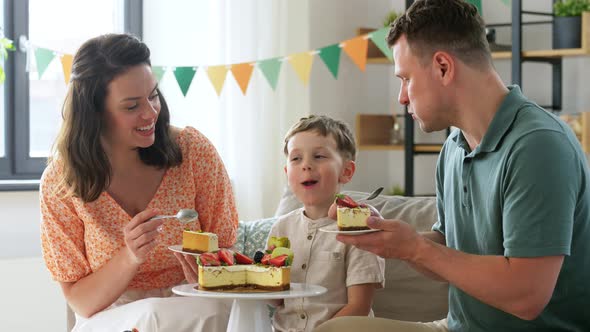 Happy Family Eating Birthday Cake at Home Party alt