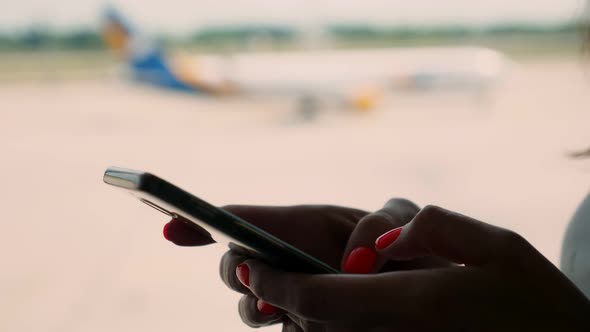 Close-up, Female Hands Are Typing Text Message on a Mobile, Smartphone. Background of Panoramic alt