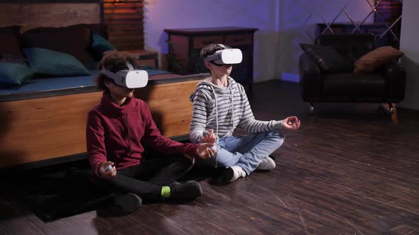 Boys in VR Glasses Meditating in Lotus Pose alt