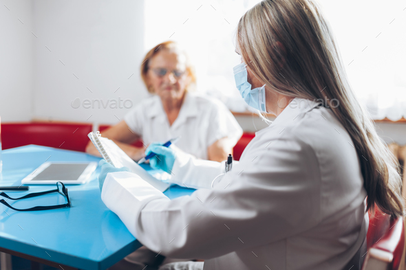 Senior woman during a medical exam with practitioner - Stock Photo - Images