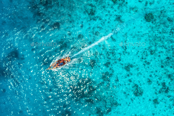 Aerial view of the fishing boat in transparent blue water - Stock Photo - Images