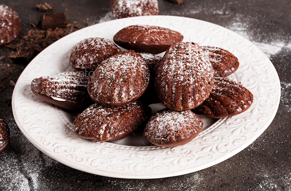 Chocolate cookies. Homemade Chocolate Madeleines on dark table. French cuisine.