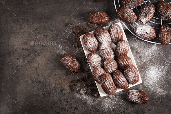 Chocolate cookies. Homemade Chocolate Madeleines on dark table. French cuisine. Top view