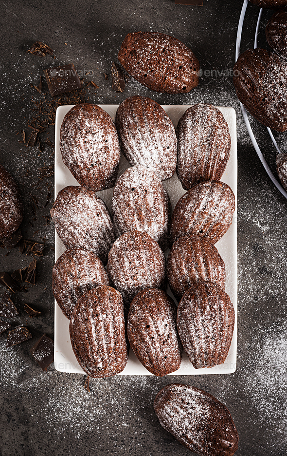Chocolate cookies. Homemade Chocolate Madeleines on dark table. French cuisine. Top view