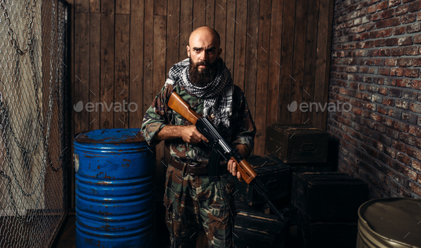Terrorist in uniform holds kalashnikov rifle - Stock Photo - Images