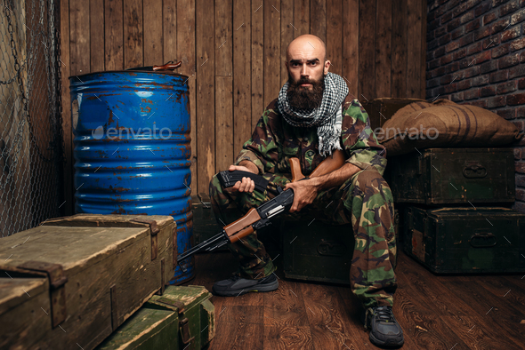Terrorist inserts magazine into kalashnikov rifle - Stock Photo - Images