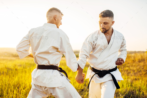 Two karate fighters on outdoor training fight - Stock Photo - Images