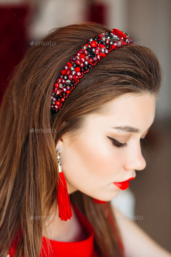 Above view of brunette girl wearing in shiny red hand band - Stock Photo - Images