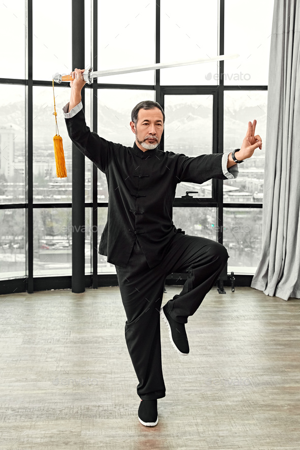 Couple of senior masters practicing qi qong taijiquan - Stock Photo - Images
