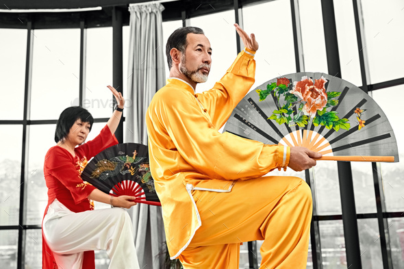Couple of senior masters practicing qi qong taijiquan - Stock Photo - Images
