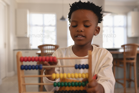 Download Front View Of Cute African American Boy Learning Mathematics With Abacus In A Comfortable Home Stock Photo By Wavebreakmedia
