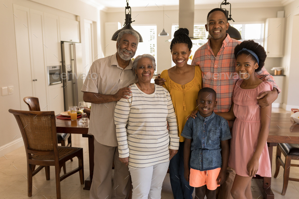 Portrait of happy multi-generation African American family standing together at home