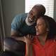 Front view of an active senior couple having fun in living room at home - $5.00 Front view of an active senior couple having fun in living room at home