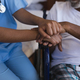 Mid section of young African American female doctor consoling senior African American man at home - $5.00 Mid section of young African American female doctor consoling senior African American man at home