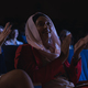 Low angle view of mixed race businesswoman sitting and clapping in the auditorium - $5.00 Low angle view of mixed race businesswoman sitting and clapping in the auditorium