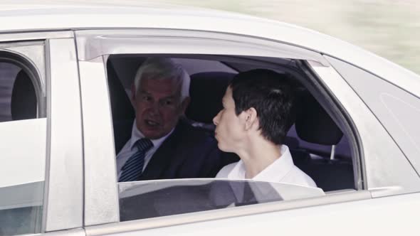 Businesspeople Chatting in Moving Car alt
