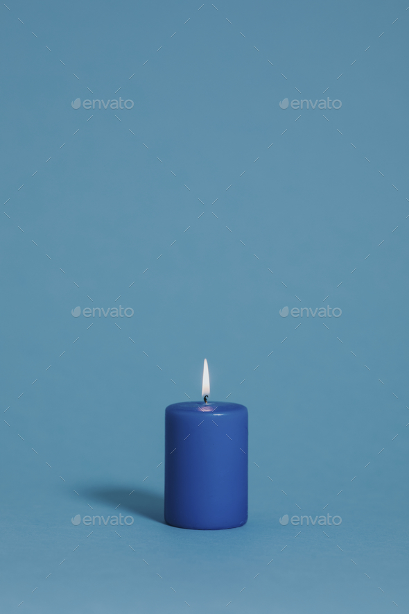 Blue candle on blue - Stock Photo - Images