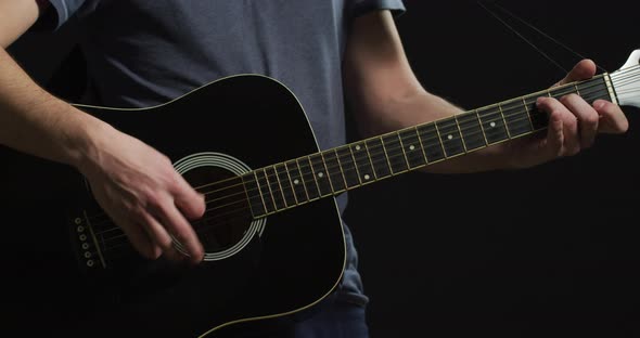 Man playing an acoustic guitar alt
