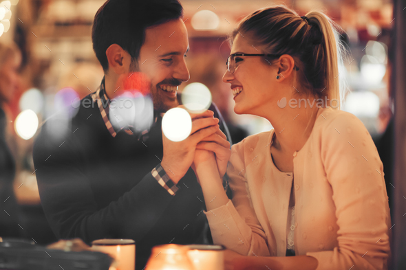 Couple dating at night in pub - Stock Photo - Images