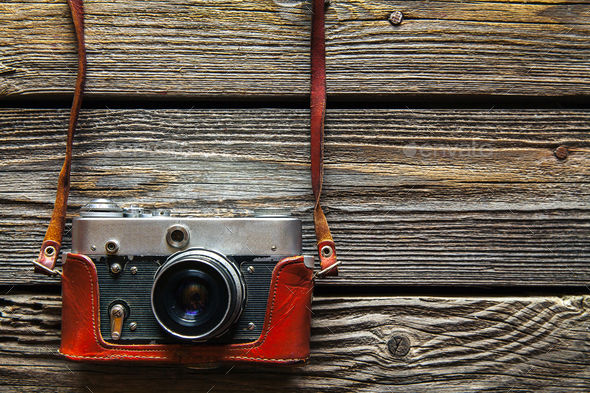 Retro camera on wood table background, vintage color tone - Stock Photo - Images