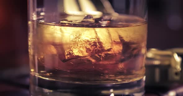 Spinning and melting ice and whisky in the glass on old diary alt
