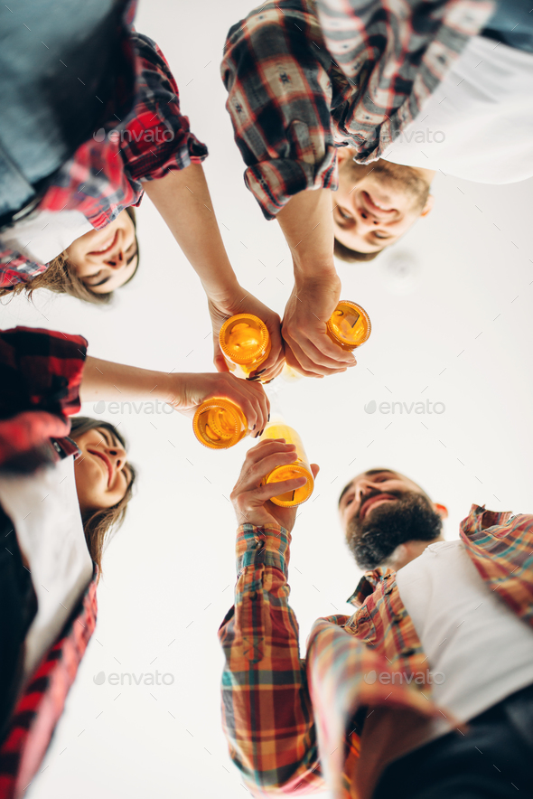 Friends clink bottles with beer, bottom view - Stock Photo - Images