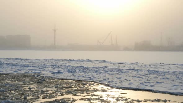 View At The Frozen Bay With Winter Sun And City Silhouette, Winter Landscape