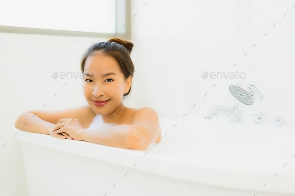 young woman relaxing and takes bubble bath in bathtub with foam, People  Stock Footage ft. woman & bath - Envato Elements