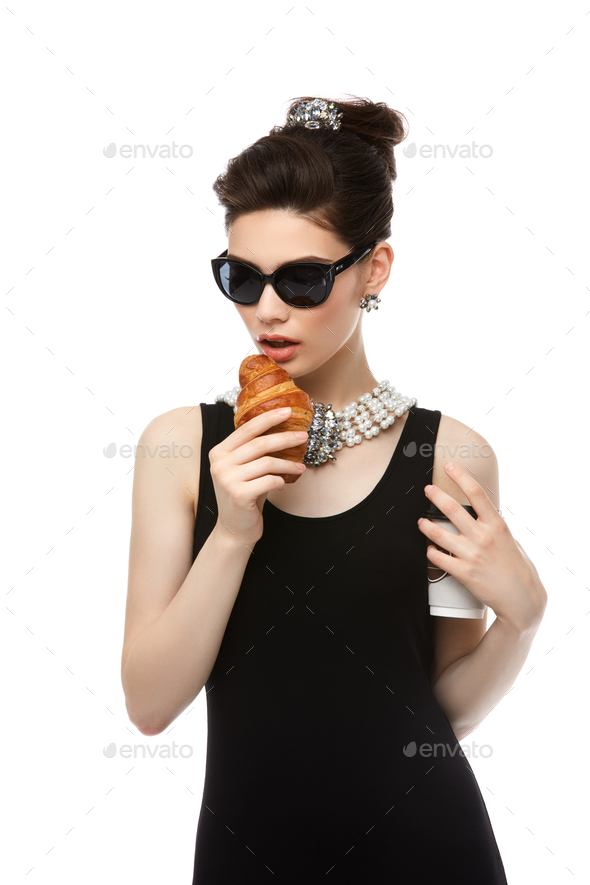 beautiful young woman in retro style with croissant - Stock Photo - Images