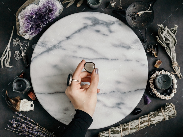Witch's hand holds Smoky quartz - Stock Photo - Images
