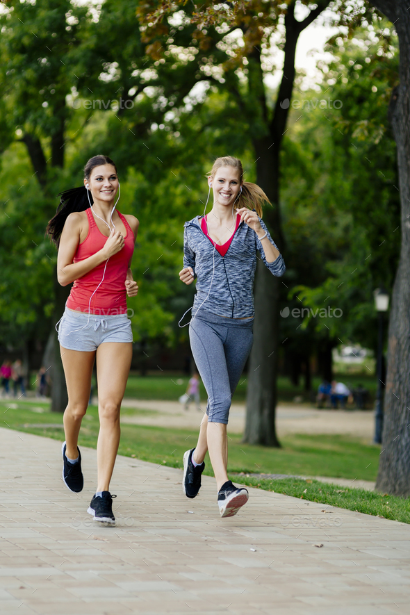 Two women jogging in park Stock Photo by nd3000
