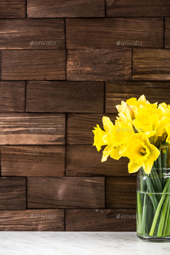 Spring yellow Daffodils flowers in vase, on wooden background Stock Photo  by merc67