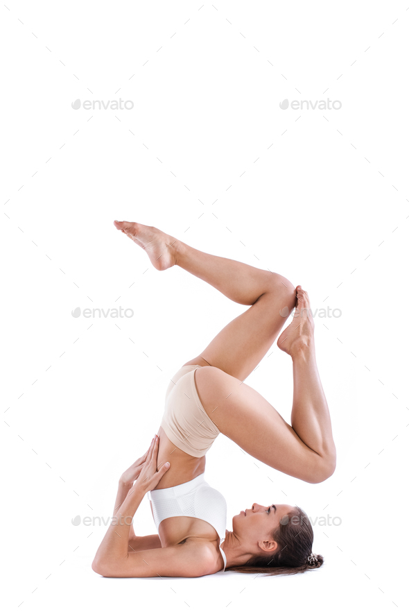 Yoga woman with perfect body practicing yoga poses full length in studio  isolated on white. Stock Photo by MediaGroupBestForYou