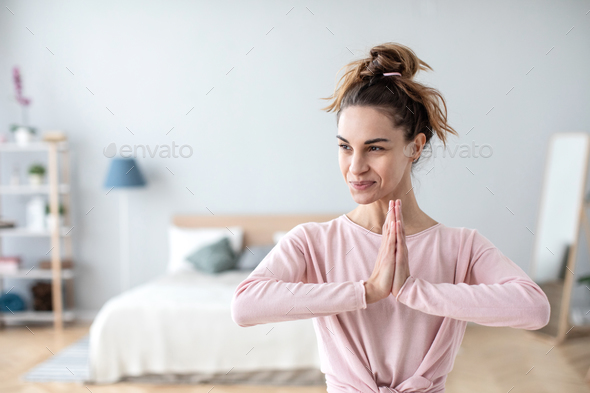 Portrait attractive smiling yogi woman in meditating pose.