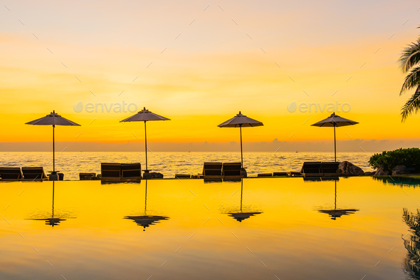 Umbrella And Chair Around Swimming Pool In Resort Hotel For Leis