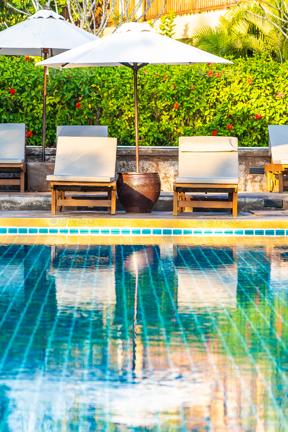 Umbrella And Chair Around Swimming Pool In Hotel Resort Neary Se